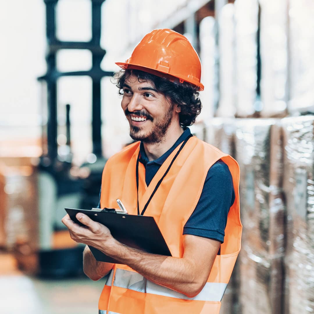 Young. man with hard hat and vest on working on a construction site for construction line of credit post.