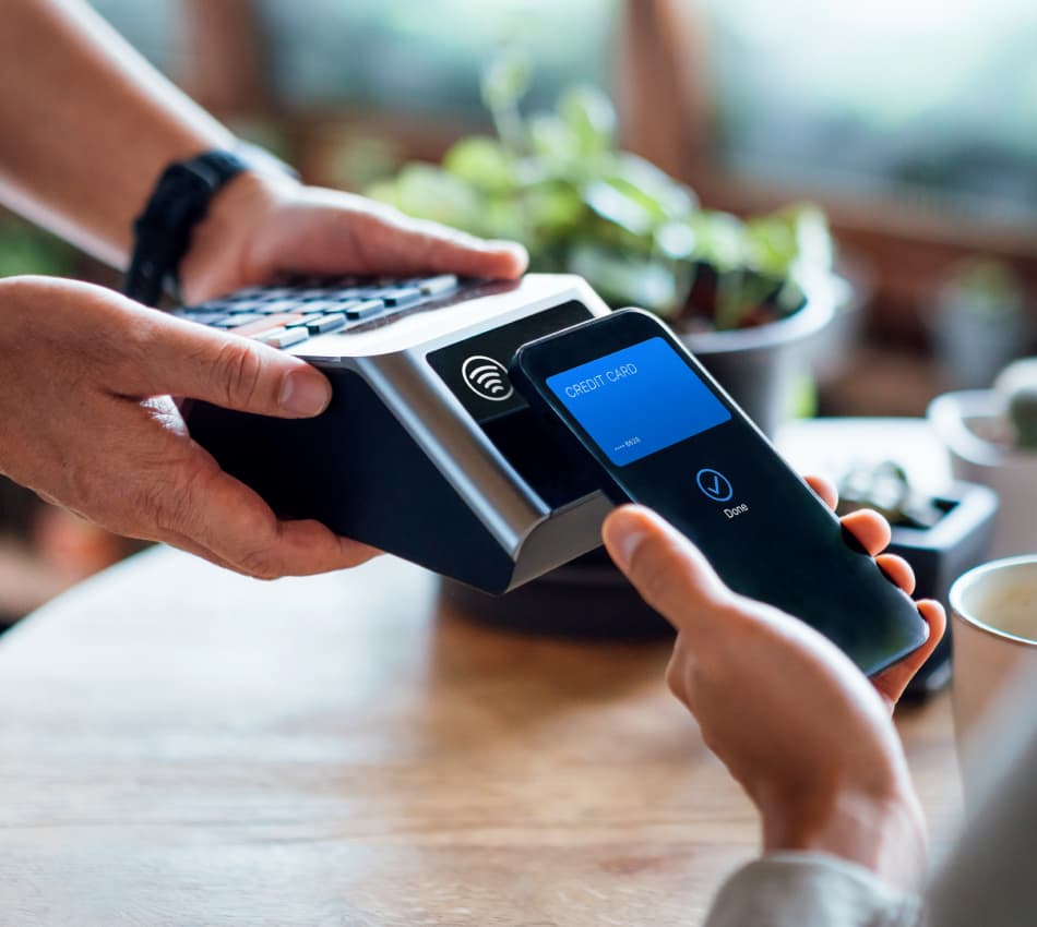 Close-up of someone making a contactless credit card transaction via mobile wallet.